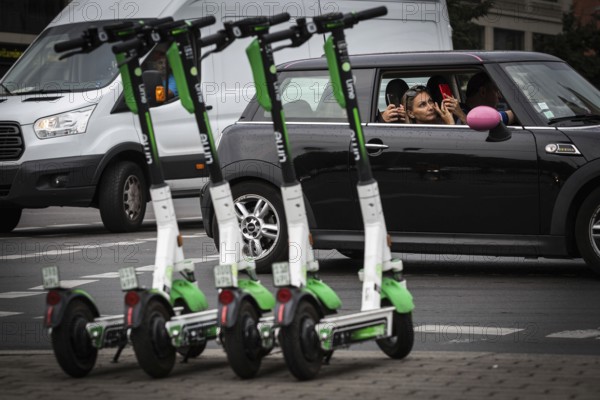 DEU Germany Germany Berlin Traffic passes parked e-scooters on Karl-Liebknecht-Str