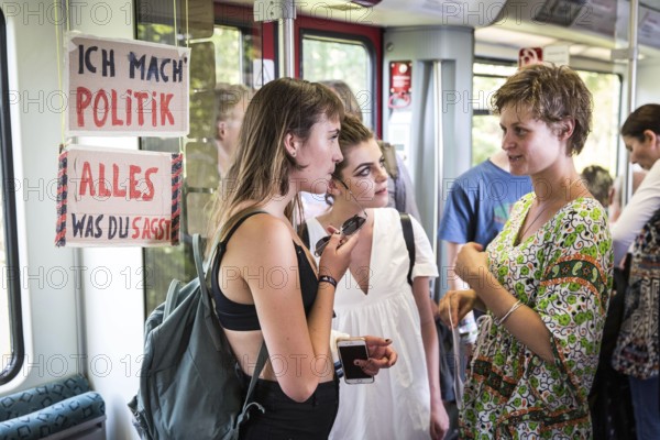 DEU Germany Germany Berlin Students discuss the G20 summit on the Berlin S-Bahn. A loose group of activists meet irregularly to discuss political issues with passengers over tea and food on the Ringbahn railway line