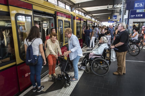 DEU Germany Germany Berlin A woman with a walker leaves the S-Bahn at Zoo station