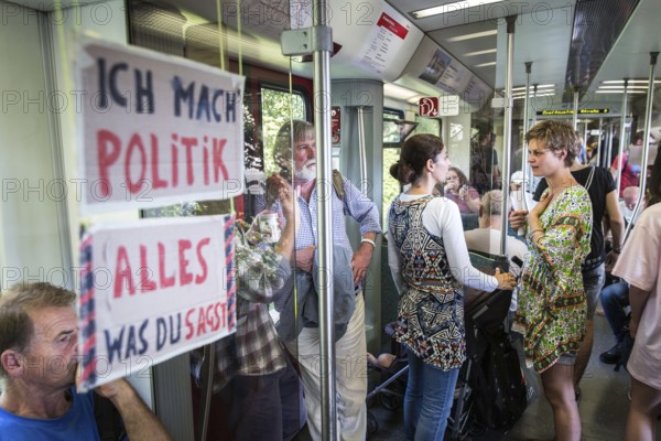 DEU Germany Germany Berlin Students discuss the G20 summit on the Berlin S-Bahn. A loose group of activists meet irregularly to discuss political issues with passengers over tea and food on the Ringbahn railway line