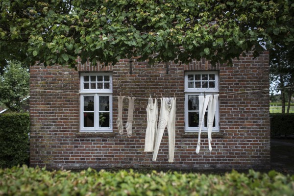 DEU Germany Germany Moordorf Historic clothing hangs on a washing line at the Moor Museum. The museum shows the poor conditions under which moor engravers worked in the 19th century
