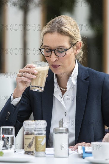 DEU Germany Germany Berlin AFD top candidate Alice Weidel drinks a cafe latte in front of a press conference on asylum and development policy