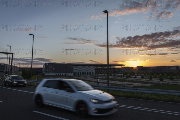 DEU Germany Germany Berlin Cars pass the future BER Berlin-Brandenburg airport at sunset