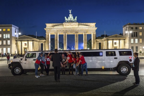 DEU Germany Germany Berlin Bride with friends posing in front of stretch limousine in front of the Brandenburg Tor tor