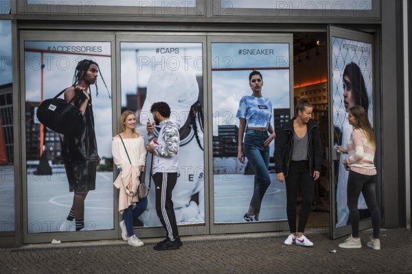 DEU Germany Germany Berlin Teeenager in front of a shop at Alexanderplatz
