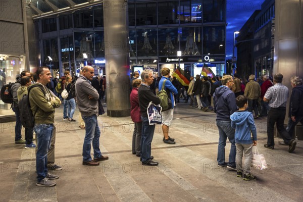 DEU Germany Germany Dresden Pegida demonstration in the city centre. Spectators in front of a department store
