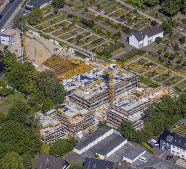Aerial view, construction site new residential buildings, former Opel car dealership Brinkmann site, Bredenscheider Straße, Evang. Cemetery at the water tower, Hattingen, Ruhr area, North Rhine-Westphalia, Germany, construction area, building site, building plots, building crane, construction project, construction site, burial site, DE, Ennepe-Ruhr district, Europe, cemetery, memorial, place of worship, graves, burial ground, capacity requirement, aerial photograph, aerial photography, aerial photography, new building, resting place, overview, bird's-eye view, living and life, birds-eyes view, overview