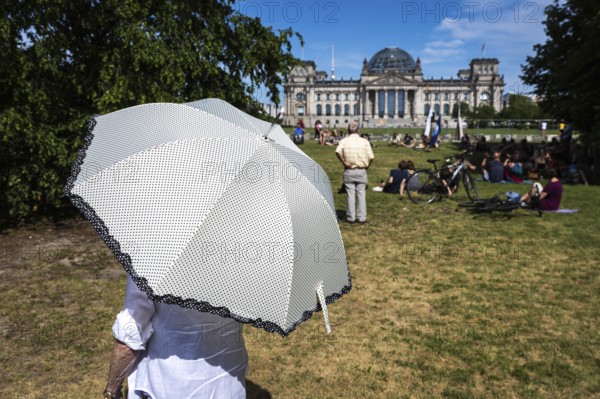 DEU Germany Germany Berlin Impressions of the climate camp attended by up to 100 activists over Whitsun with a view of the Reichstag.woman with parasol