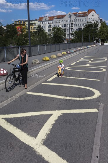 DEU Germany Germany Berlin Cyclists pass the closed Monumentenbrücke bridge in Schöneberg. The bridge is temporarily closed to motorised traffic due to damage
