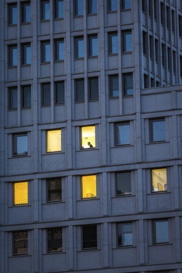 DEU Germany Germany Berlin A man sits in an illuminated office in the Beisheim Centre