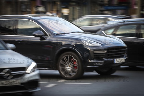 DEU Germany Germany Berlin An SUV, Porsche Cayenne, takes off on the Kudamm