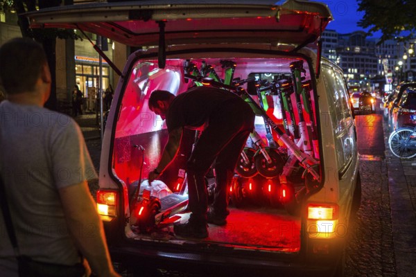 DEU Germany Germany Berlin So-called juicers collect discharged electric scooters at Potsdamer Platz