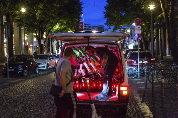 DEU Germany Germany Berlin So-called juicers collect discharged electric scooters at Potsdamer Platz