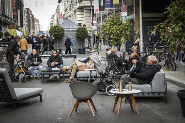 DEU Germany Germany Berlin Part of Friedrichsstrasse is closed to traffic at the weekend. Pedestrians use the street for a stroll or to sit on a sofa
