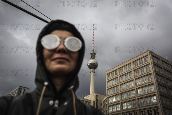 DEU Germany Germany Berlin Demonstration against rent increases and gentrification Participant with glasses in front of Alexanderplatz