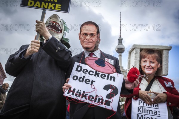 DEU Germany Germany Berlin Demonstration against rent increases and gentrification. rent shark, Angela Merkel and the Governing Mayor Michael Müller as protest masks