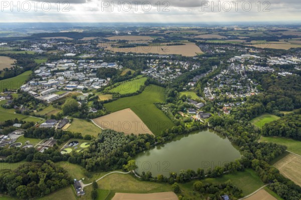 Aerial view, industrial estate Hetterscheidt-Nord, Dieselstraße, Abtskücher Teich, chapel St. Jakobus Abtsküche, Museum Abtsküche, view of Hetterscheidt, Heiligenhaus, Ruhr area, North Rhine-Westphalia, Germany, place of worship, DE, Europe, commercial enterprises, commercial area, commercial park, commercial location, commercial use, religious community, place of worship, green trees, local history collection, Heiligenhaus historical society, industrial area, industrial site, chapel, church, church community, denomination, aerial view, aerial photography, aerial photography, museum, religion, overview, bird's-eye view, forest area, birds-eyes view, overview