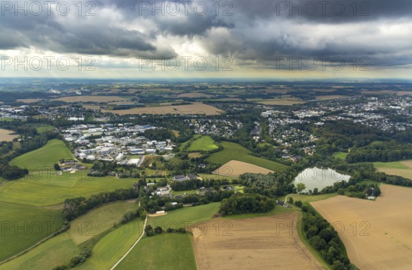 Aerial view, industrial estate Hetterscheidt-Nord, Dieselstraße, Abtskücher Teich, chapel St. Jakobus Abtsküche, Museum Abtsküche, view of Hetterscheidt, Heiligenhaus, Ruhr area, North Rhine-Westphalia, Germany, place of worship, DE, Europe, commercial enterprises, commercial area, commercial park, commercial location, commercial use, religious community, place of worship, green trees, local history collection, Heiligenhaus historical society, industrial area, industrial site, chapel, church, church community, denomination, aerial view, aerial photography, aerial photography, museum, religion, overview, bird's-eye view, forest area, birds-eyes view, overview