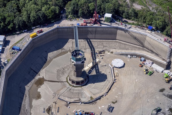 Aerial photo, RWE has completely emptied the large upper reservoir for the main inspection at the Herdecke pumped storage power plant. The plant will be off the grid for a few weeks, storage reservoir, RWE pumped storage power plant, Köpchenwerk, Herdecke, Ruhr area, North Rhine-Westphalia, Germany<, construction work, construction area, construction measure, construction project, construction site, DE, Germany, Europe, Ruhr river, Hengsteysee, aerial photograph, aerial photography, aerial photography, pumped storage power plant Köpchenwerk, RWE, lake, overview, bird's-eye view, forest area, birds-eyes view, overview