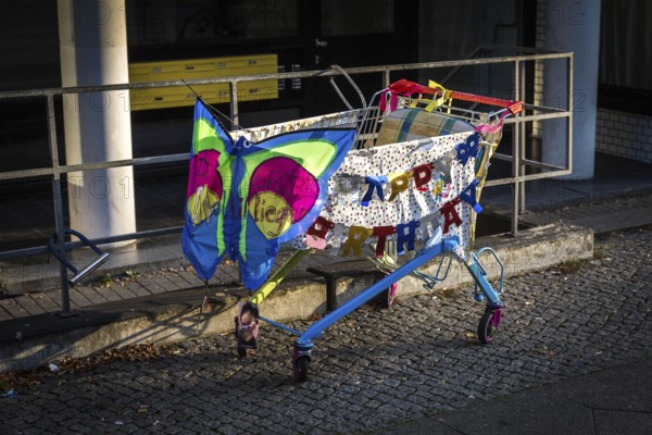 DEU Germany Germany Berlin A shopping trolley decorated for a birthday is parked on Potsdamer Strasse