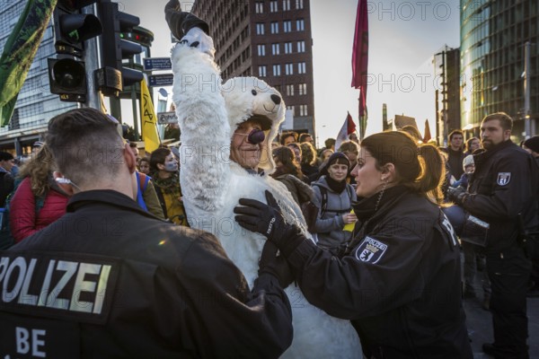 DEU Germany Germany Berlin Protesters of the Extinction Rebellion movement during the occupation of Potsdamer Platz.a man in a polar bear costume is held back by two policemen