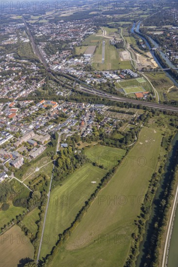 Aerial photograph, Hamm airfield, Mattenbecke sewage treatment plant, Lippe floodplain, River Lippe, Datteln-Hamm canal, Hamm, Ruhr area, North Rhine-Westphalia, Germany, wastewater treatment plant, wastewater treatment, railway tracks, construction site, burial ground, DE, Europe, flight emission, airport, aircraft noise, airfield, airfield site, cemetery, memorial, place of worship, graves, burial ground, sewage treatment plant, runway, aerial view, aerial photography, aerial photography, Münsterstrasse, Nordenfriedhof, resting place, runway, overview, bird's-eye view, water treatment plant, water purification plant, birds-eyes view, overview
