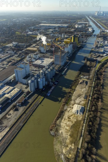Aerial view, harbour Hamm, Jäckering oil mill, oil mill Brökelmann, Brölio, industrial estate north, river Lippe, Datteln-Hamm canal, Hamm, Ruhr area, North Rhine-Westphalia, Germany, bridge, DE, Deutag West Zweigniederlassung der Basalt-Actien-Gesellschaft, Europe, distant view, river, river course, industrial area, industrial estate, industrial park, commercial use, harbour road, industrial plants, industrial area, industrial site, canal, sewage treatment plant Hamm Norden, aerial view, aerial photography, aerial photography, production plants, production halls, RWE Power AG power plant Gersteinwerk, Radbodstraße, Raiffeisen Vital Mischfutter GmbH, Speicherstraße, overview, bird's-eye view, birds-eyes view, overview