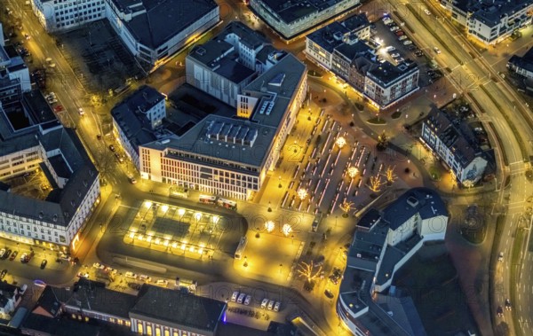 Aerial view, night view of Hamm main station, Bahbofsvorplatz, Hamm library, Platz der Deutschen Einheit, Bahnhofstraße, Neue Bahnhofstraße, Herlitz, Gustav-Heinemann-Straße, Heinrich-von-Kleist-Forum. VHS-Hamm, centre, Hamm, Ruhr area, North Rhine-Westphalia, Germany, DE, Europe, birds-eyes view, aerial view, aerial photography, aerial photography, overview, bird's-eye view, night view, twilight view, Hamm at night