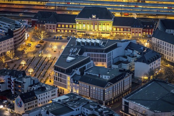 Aerial view, night view of Hamm main station, Bahbofsvorplatz, Hamm library, Platz der Deutschen Einheit, Bahnhofstraße, Neue Bahnhofstraße, Herlitz, Gustav-Heinemann-Straße, Heinrich-von-Kleist-Forum. VHS-Hamm, centre, Hamm, Ruhr area, North Rhine-Westphalia, Germany, DE, Europe, birds-eyes view, aerial view, aerial photography, aerial photography, overview, bird's-eye view, night view, twilight view, Hamm at night