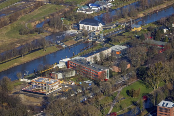Aerial view, new construction water sports centre, construction area Adenauerallee, Gymnasium Hammonense, Hamm, Ruhr area, North Rhine-Westphalia, Germany, construction work, construction vehicles, construction area, construction site, building plots, construction crane, construction measure, construction project, construction site, education, educational institution, DE, development, Europe, grammar school, canal edge, teaching institute, aerial view, aerial photography, aerial photography, new construction, school, overview, bird's eye view, water sports, birds-eyes view, overview