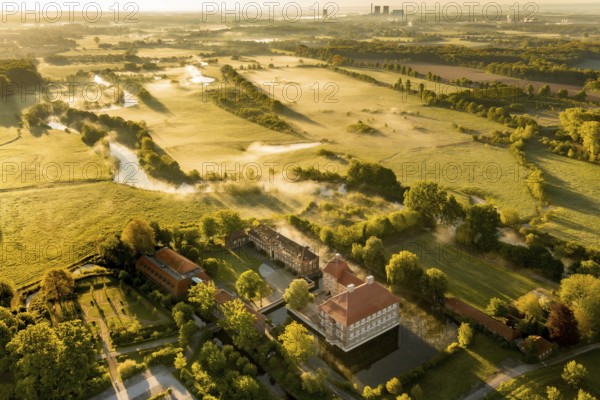 Aerial view, morning fog, Lippe river meadow, landscape in backlight, Oberwerries Castle, RWE power plant Westphalia, Hamm, Ruhr area, North Rhine-Westphalia, Germany, ground fog, castle, DE, Europe, distant view, river Lippe, river meadow, backlight, green trees, manor house, manor, manor house, manor house, power station, landscape, aerial view, aerial photography, aerial photography, fog, castle, castle grounds, castle garden, castle park, overview, bird's eye view, moated castle, moated castle, meadows and fields, birds-eyes view, overview