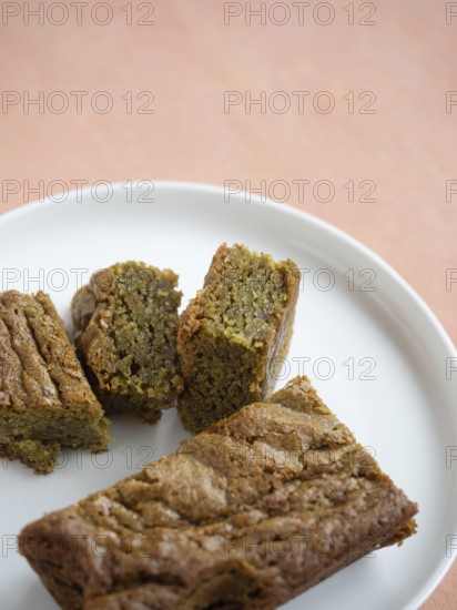 Green tea blondie bars on a white plate ready for a sweet snack