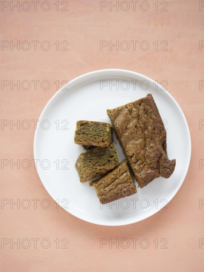 Group of matcha blondies on a white plate, prepared for a sweet treat