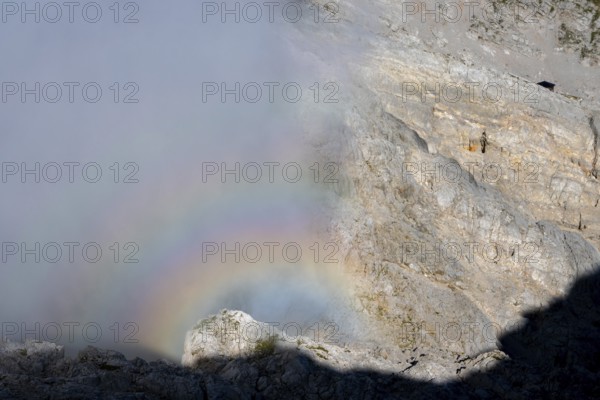 Rainbow in fog on the Steinernes Meer near the visible Wildalmkirchl bivouac, Berchtesgaden Alps, Austria
