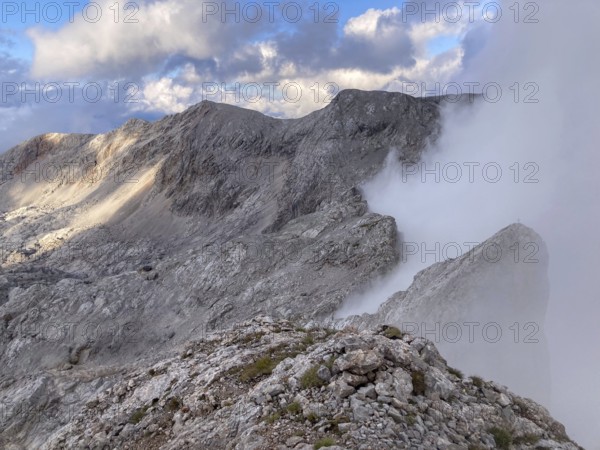 View from the summit of Wildalmkirchl with fog on the southern edge of the Steinernes Meer, Berchtesgaden Alps, Austria