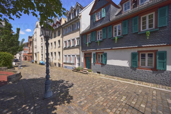 Historic building, houses, dormers, façade with windows, stairs and door, paving stone walkway, lantern, trees, bushes, blue sky, cumulus clouds, Rochusstraße, Mainz, state capital, district-free city, Rhineland-Palatinate, Germany