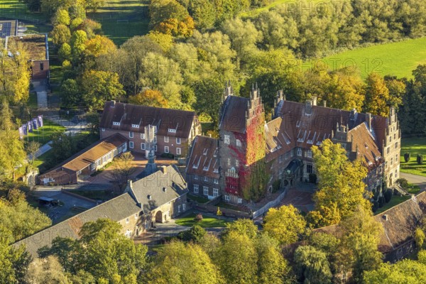 Aerial view, Heessen Castle private school and boarding school, colorful house façade with plant growth, stork nest on the roof fireplace, autumn trees, Heeßen district, Hamm, Ruhr area, North Rhine-Westphalia, Germany, castle, trees in autumn colors, DE, roof, Europe, autumn, autumn colors, autumn atmosphere, aerial photography, aerial photography, nest, castle, stork tower, overview, bird's-eye view, bird's-eye view, birch DS-eyes view, overview