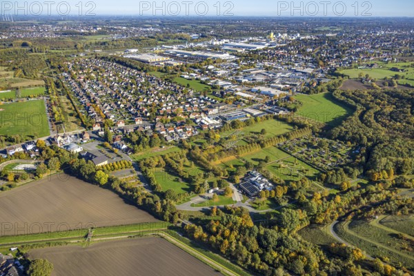 Aerial view, Isenbecker Hof residential area, Neue Kolonie mining settlement, Herringen park cemetery, Hamm Krematorium GmbH, Lippepark barefoot path, in the back the Hafenstraße industrial park, autumn trees, Herringen district, Hamm, Ruhr area, North Rhine-Westphalia, Germany, workers' housing estate, burial ground, trees in autumn colors, DE, Europe, cemetery, memorial, commercial establishment, area, commercial area, commercial property, commercial use, Gottesacker, property tax, graves, burial ground, autumn colors, autumn mood, real estate, industrial area, industrial site, aerial photography, aerial photography, resting place, overview, bird's eye view, residential complex, housing and living, residential area, residential district, residential district, birds-eyes view, overview