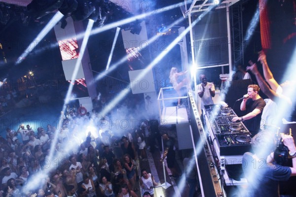 EDITORIAL and NEWS ONLY, rare moment of joint DJ back to back performance of edm dance music DJ Afrojack (raised arms) performing with DJ Hardwell (person with microphone) on DJ pult at Starbeach events festival Hersonissos, Crete, Greece, on 17. July 2017. light show, dance music, crowd, stage performance, stage lighting