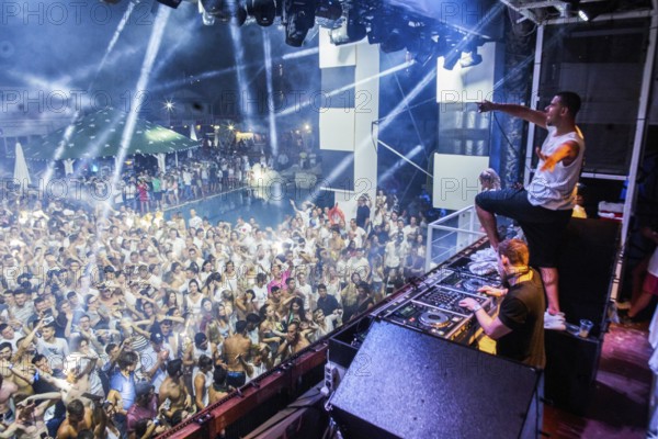 EDITORIAL and NEWS ONLY, rare moment of joint DJ back to back performance of edm dance music DJ Afrojack (on top, the person standing up on DJ pult) performing with DJ Hardwell on DJ pult at Starbeach events festival Hersonissos, Crete, Greece, on 17. July 2017, dance light show, dance music, crowd, stage performance, stage lighting