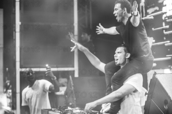 EDITORIAL and NEWS ONLY, rare moment in history of edm festivals: joint DJ back to back performance of edm dance music DJ Hardwell (on top, the person on the shoulders) performing with DJ Afrojack with DJ pult at Starbeach events festival Hersonissos, Crete, Greece, on 17. July 2017