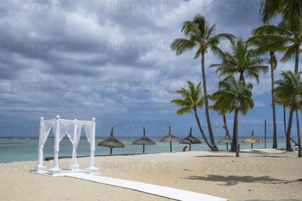 Beach, umbrellas, deckchairs, palm trees, sea, sky, clouds, wedding pavilion, Flic-en-Flac, Mauritius