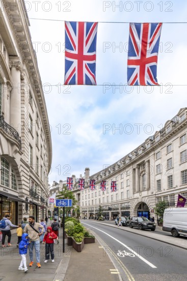 London, United Kingdom - 15 May 2025: Iconic Regent Street: sweeping curve of neoclassical buildings adorned with union jack flags
