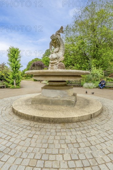 London, United Kingdom - 15 May 2025: Classic stone sculpture of a sea creature in the tranquil Rose Garden of Hyde Park
