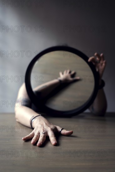 Portrait of a woman behind a mirror, interior view