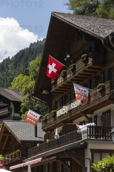 Chalets with a Swiss flag are pictured in Champery, a village in the mountains by the French border in Switzerland