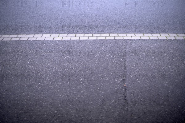 Weather conditions caused a crack in the street asphalt requiring public maintainance financed by taxpayer money to fix it and empower the public interest and economic sector that requires functional street infrastructures, Germany