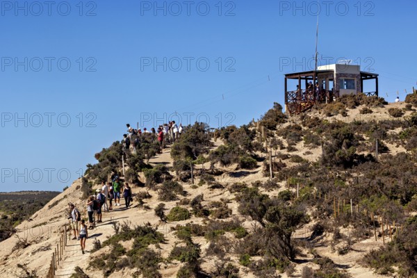 Hiker on a hill trail with views and an observation point in the blue sky, The countryside of Peninsula Valdes in Argentina