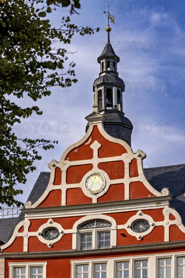 Red building with decorative bell tower, clear sky in the background, historic ambiance, the old town of Arnstadt in Thuringia