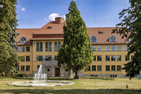 Historic building with tiled roof and fountain in the foreground, the old town of Arnstadt in Thuringia